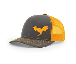 Charcoal and neon orange mesh trucker hat with a fighting fowl on the front from Swamp Cracker Outdoor Apparel.