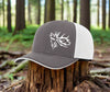 View of the front of the outdoorsman hat at Swamp Cracker Outdoor Apparel in blue and grey with an elk bugling on the front left