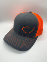 Charcoal and neon orange mesh trucker hat with a round fish hook on the front from Swamp Cracker Outdoor Apparel.