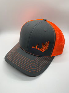 Charcoal and neon orange mesh trucker hat with a deer shed on the front from Swamp Cracker Outdoor Apparel.